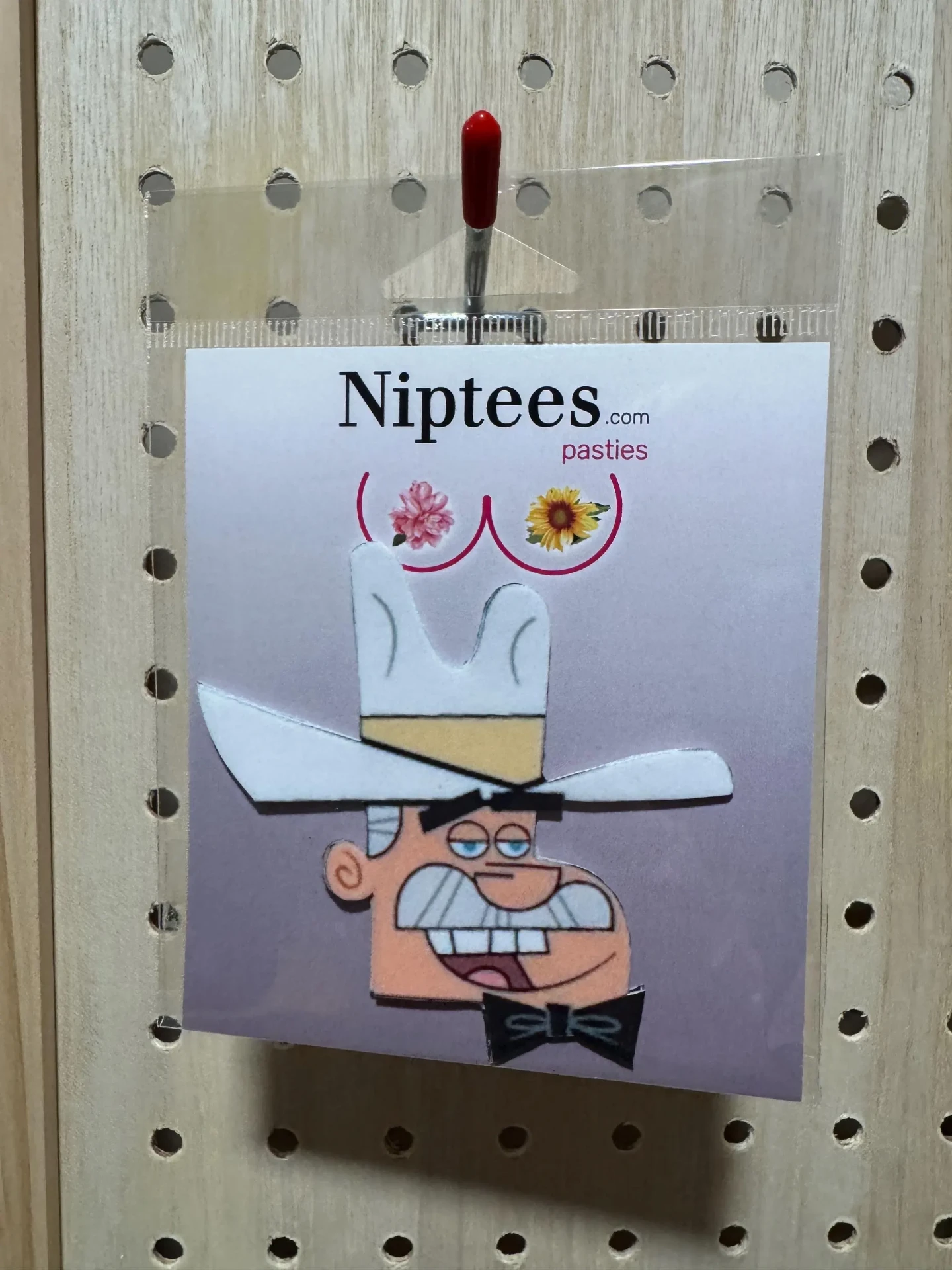 Cartoon cowboy face pastie on a Niptees backing card