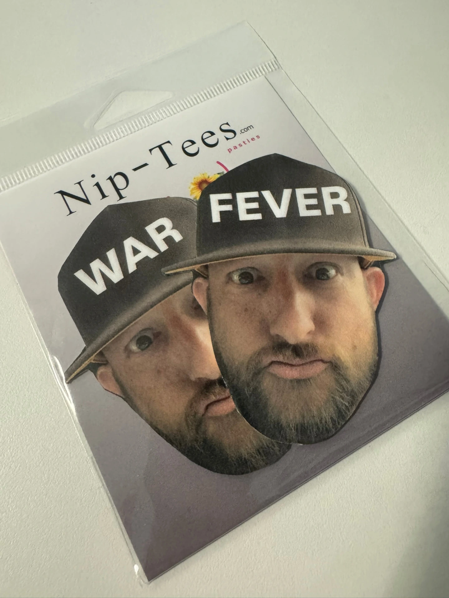 Pair of custom face pasties with matching hats, in packaging